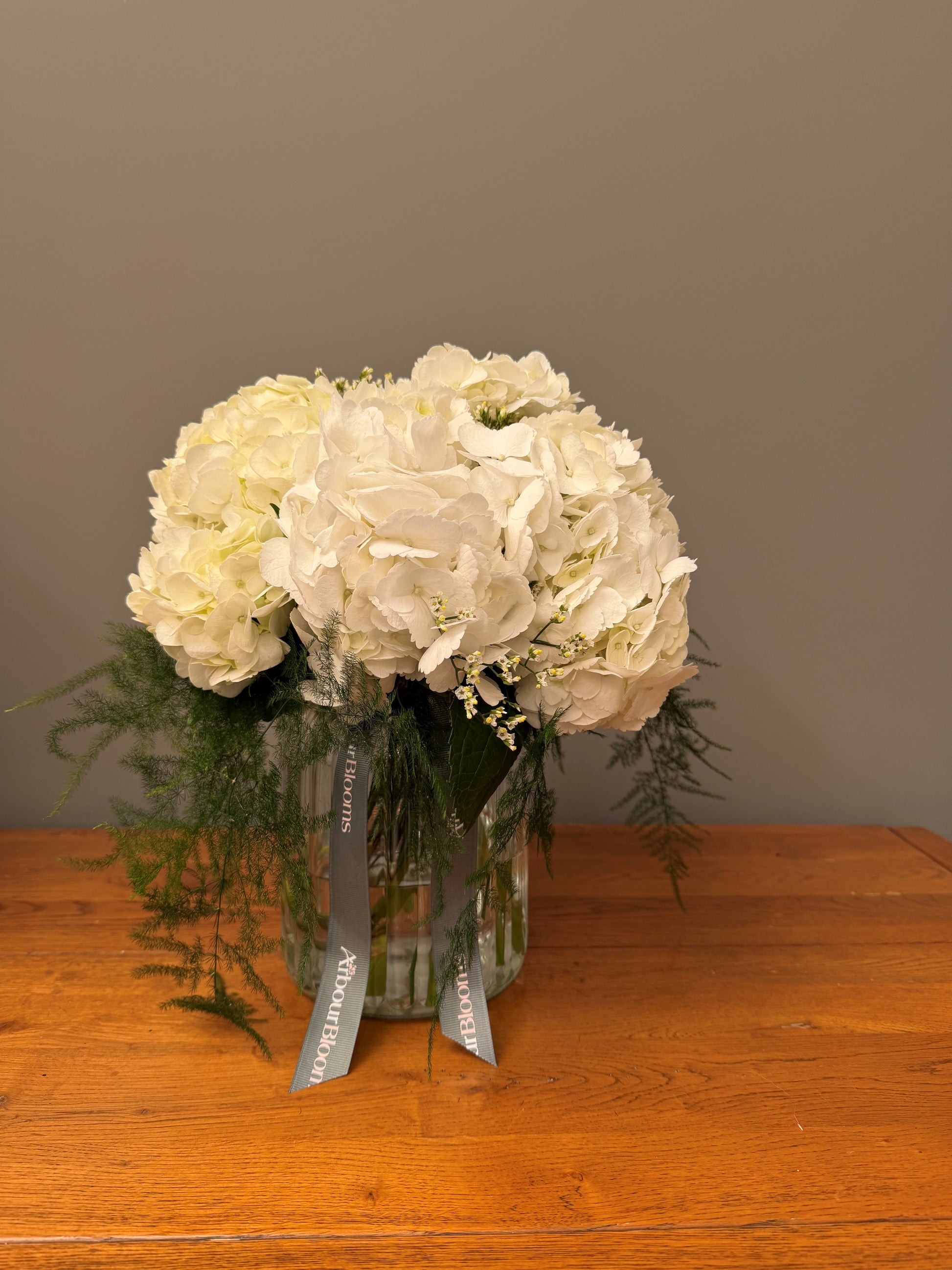 Pure White Hydrangea Vase — hand-tied white hydrangea bouquet and asparagus fern by Arbour Blooms, Dublin florist.