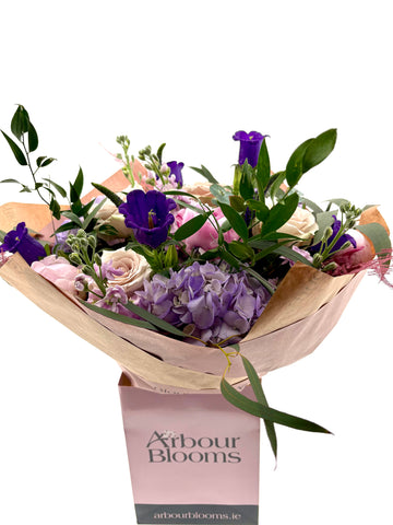 Bouquet of flowers with a visible Arbour Blooms box on a white background